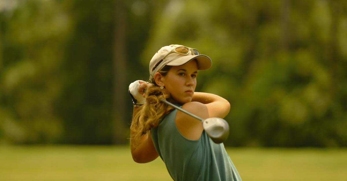 Lady playing golf on the fairway